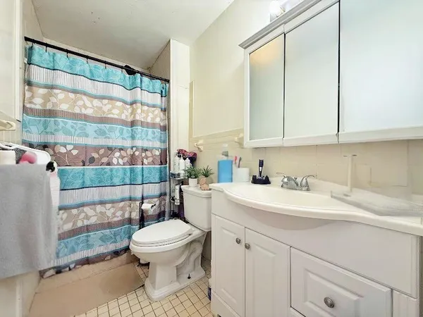 a bathroom with a sink a toilet and a large window