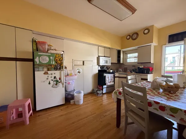 a kitchen with stainless steel appliances a refrigerator a stove a sink dishwasher and a refrigerator with wooden floor