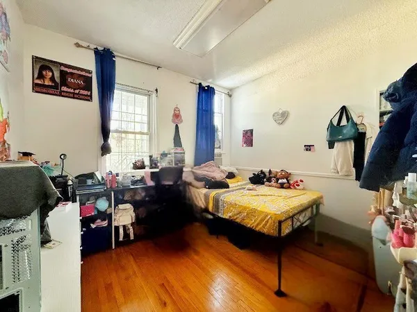 a bedroom with bed and a large window