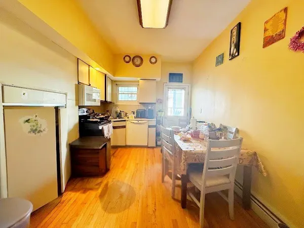 a living room with stainless steel appliances kitchen island granite countertop furniture and a refrigerator
