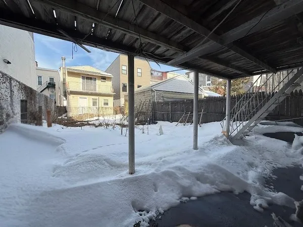 a view of a backyard with table and chairs