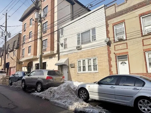 a view of a car parked in front of a house