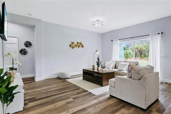 a living room with furniture and a large window