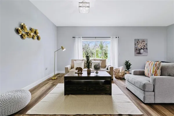 a living room with furniture and wooden floor