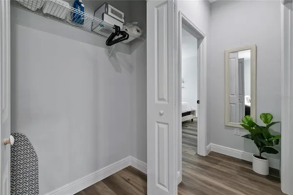 a bedroom with a bed and a flat tv screen on a dresser