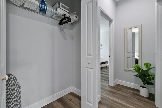 a bedroom with a bed and a flat tv screen on a dresser