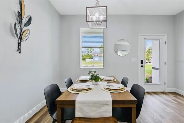 a view of a dining room with furniture and a window