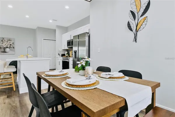 a view of a dining room with furniture and wooden floor