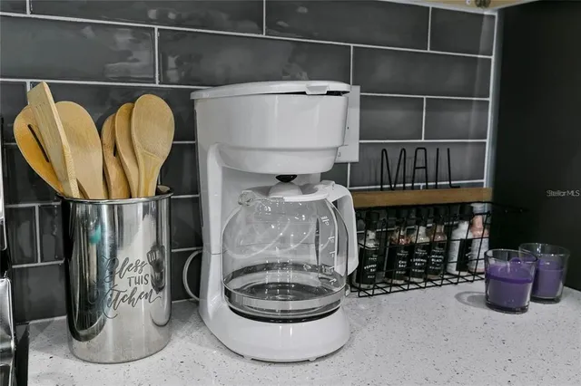 a kitchen with stainless steel appliances a stove sink microwave and cabinets