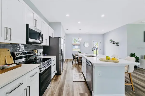 a kitchen with a sink a stove and cabinets