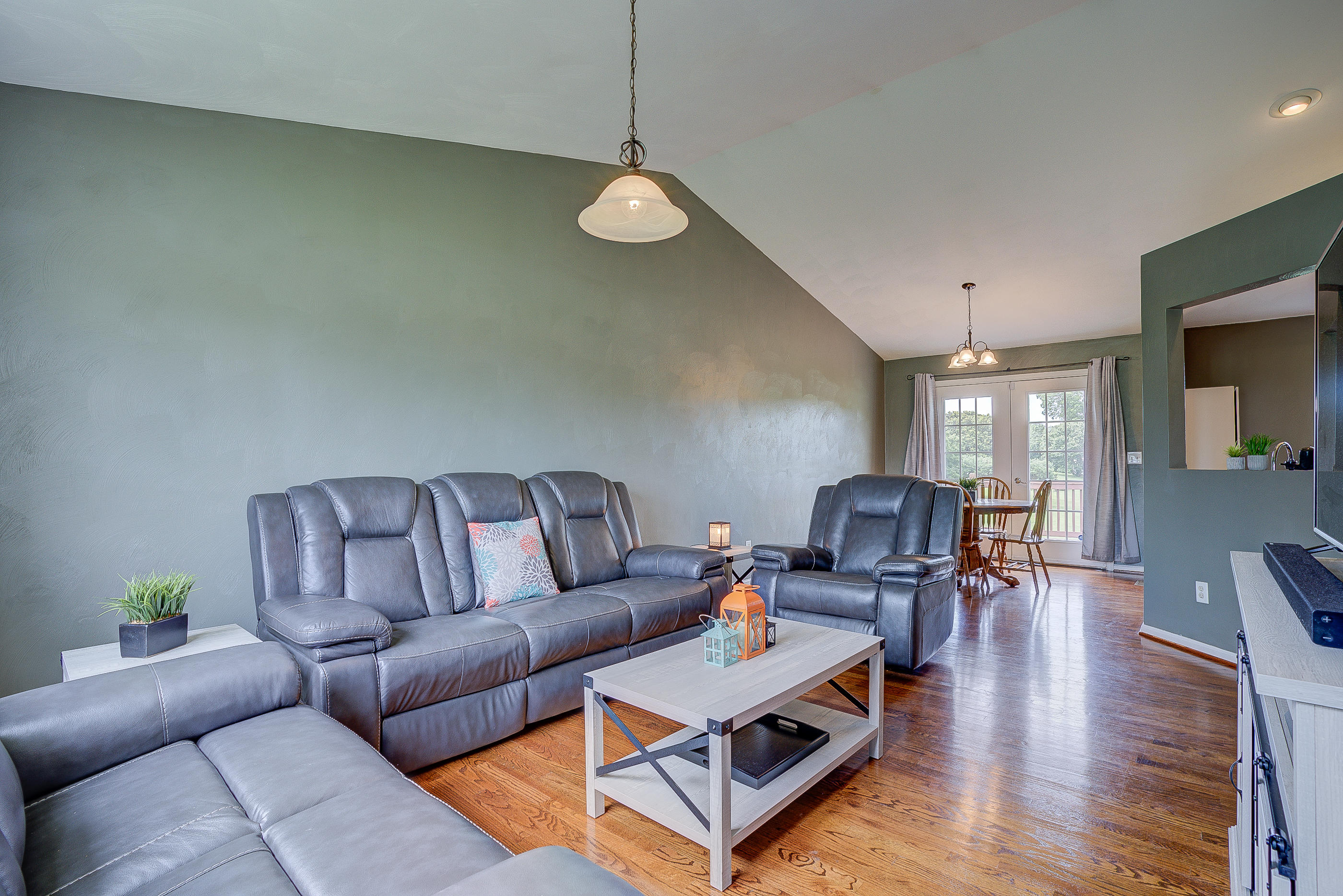 4410 Cove Road Roanoke, VA 24017 - Photo 2 of 32 a living room with furniture a fireplace and wooden floor