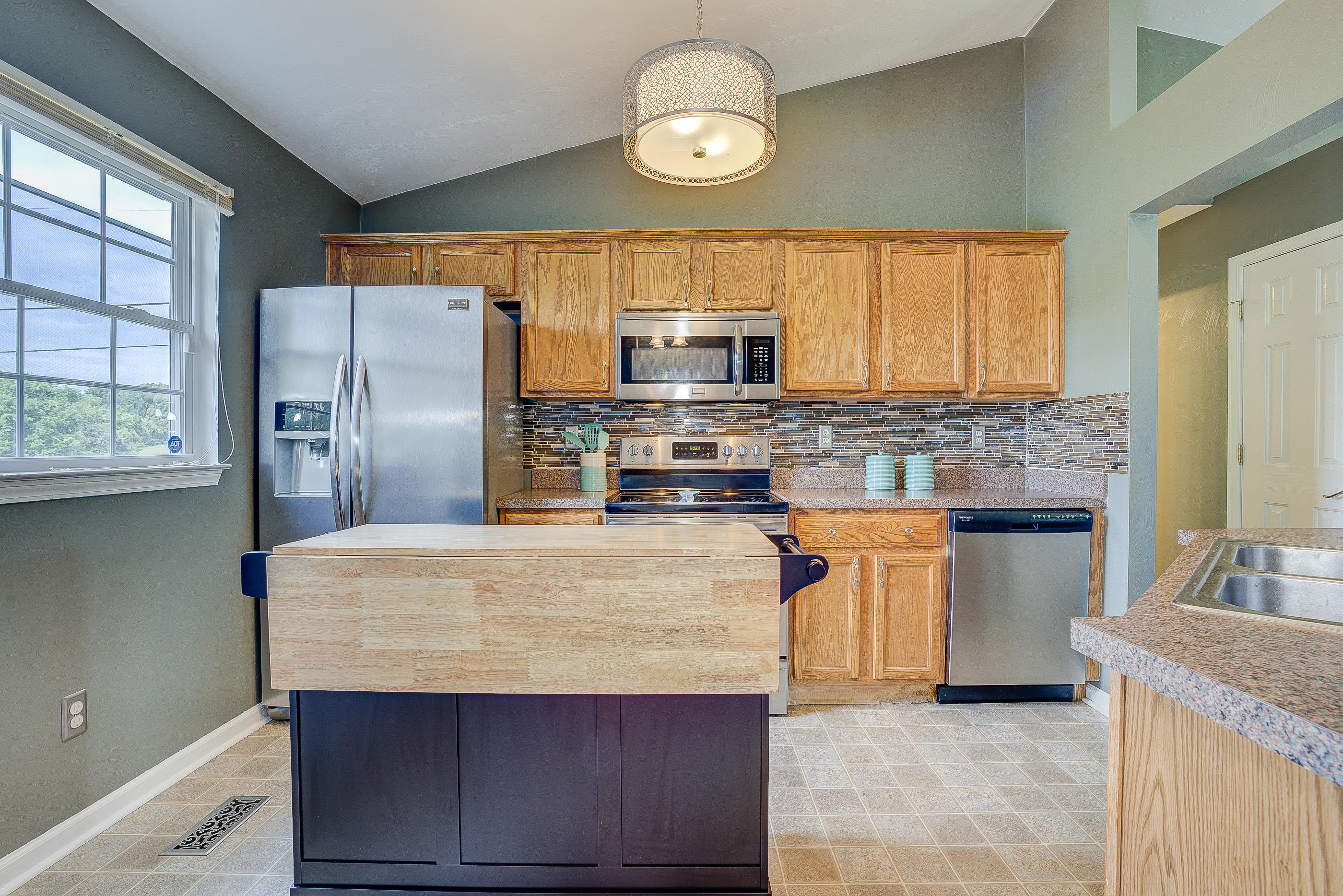 4410 Cove Road Roanoke, VA 24017 - Photo 11 of 32 a kitchen with stainless steel appliances granite countertop a sink stove and refrigerator