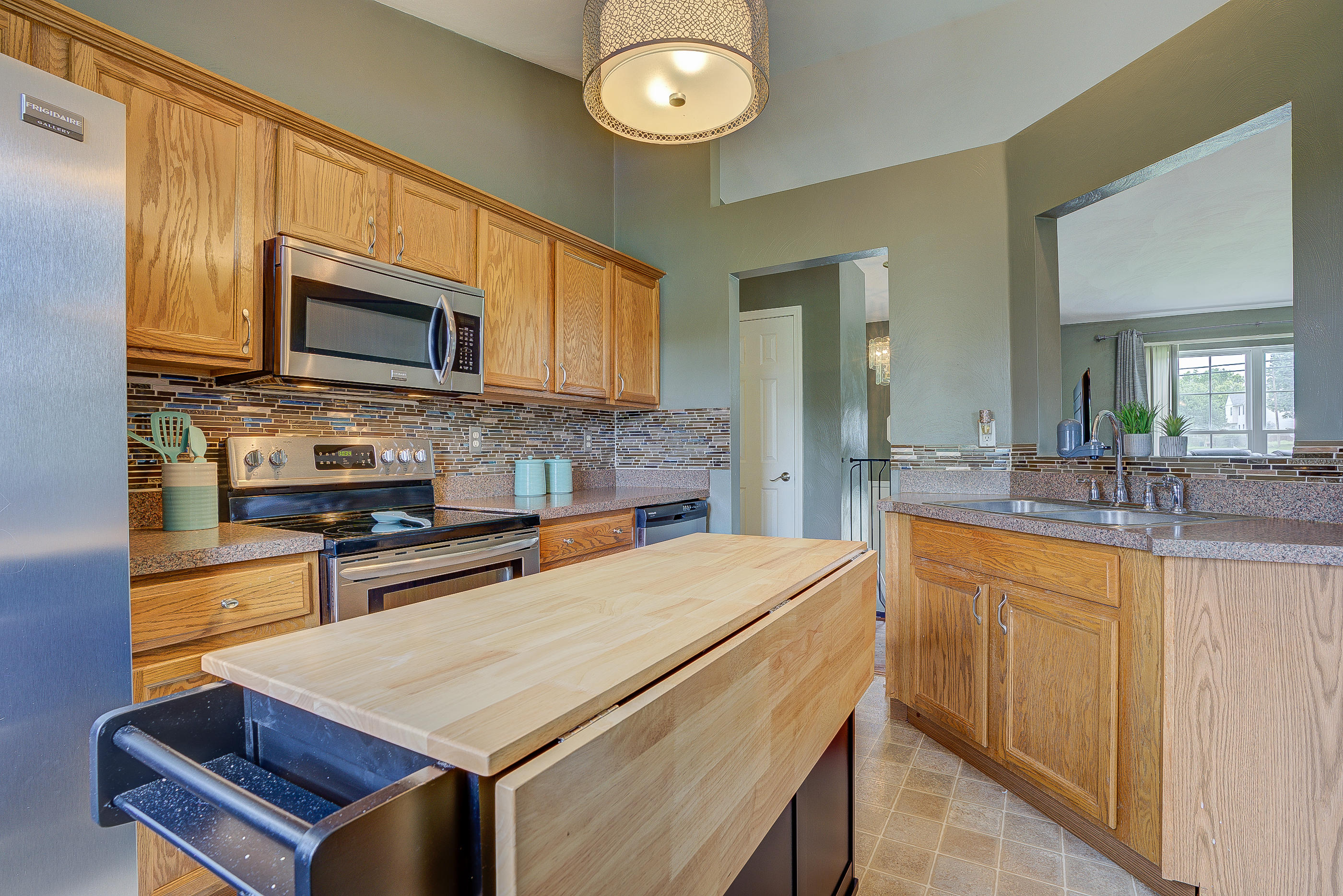 4410 Cove Road Roanoke, VA 24017 - Photo 12 of 32 a kitchen with stainless steel appliances a stove sink microwave and cabinets