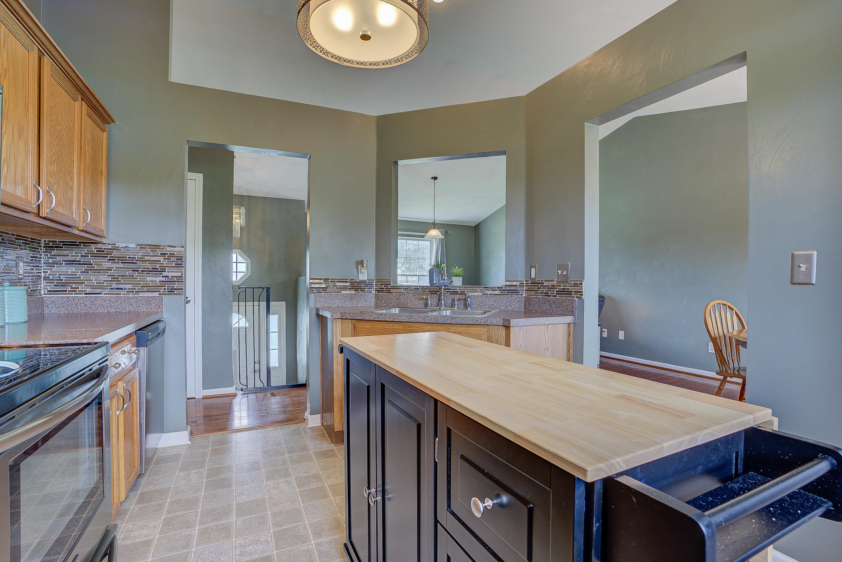 4410 Cove Road Roanoke, VA 24017 - Photo 13 of 32 a kitchen with a stove and a wooden cabinets