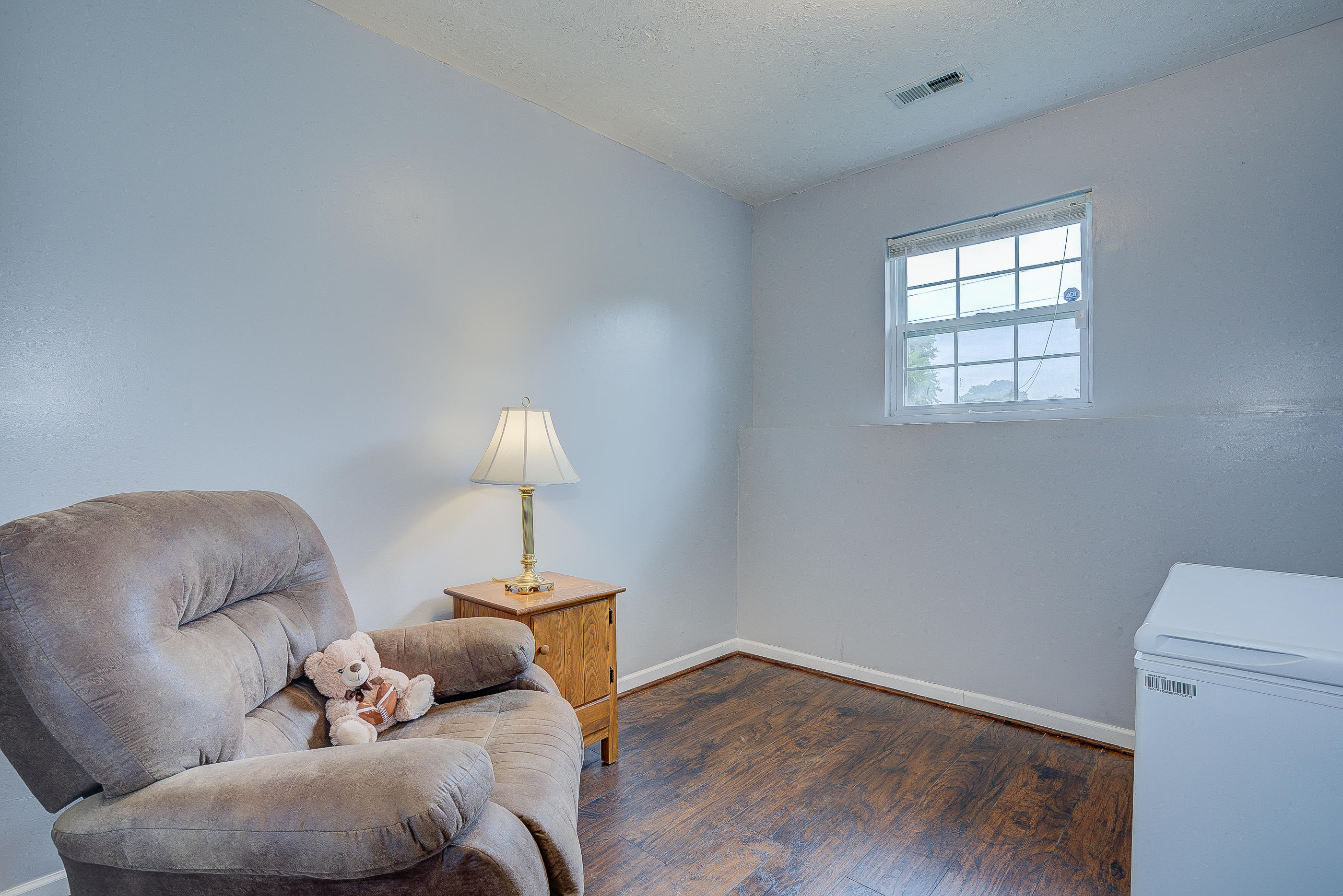 4410 Cove Road Roanoke, VA 24017 - Photo 24 of 32 a room with furniture and a wooden floor
