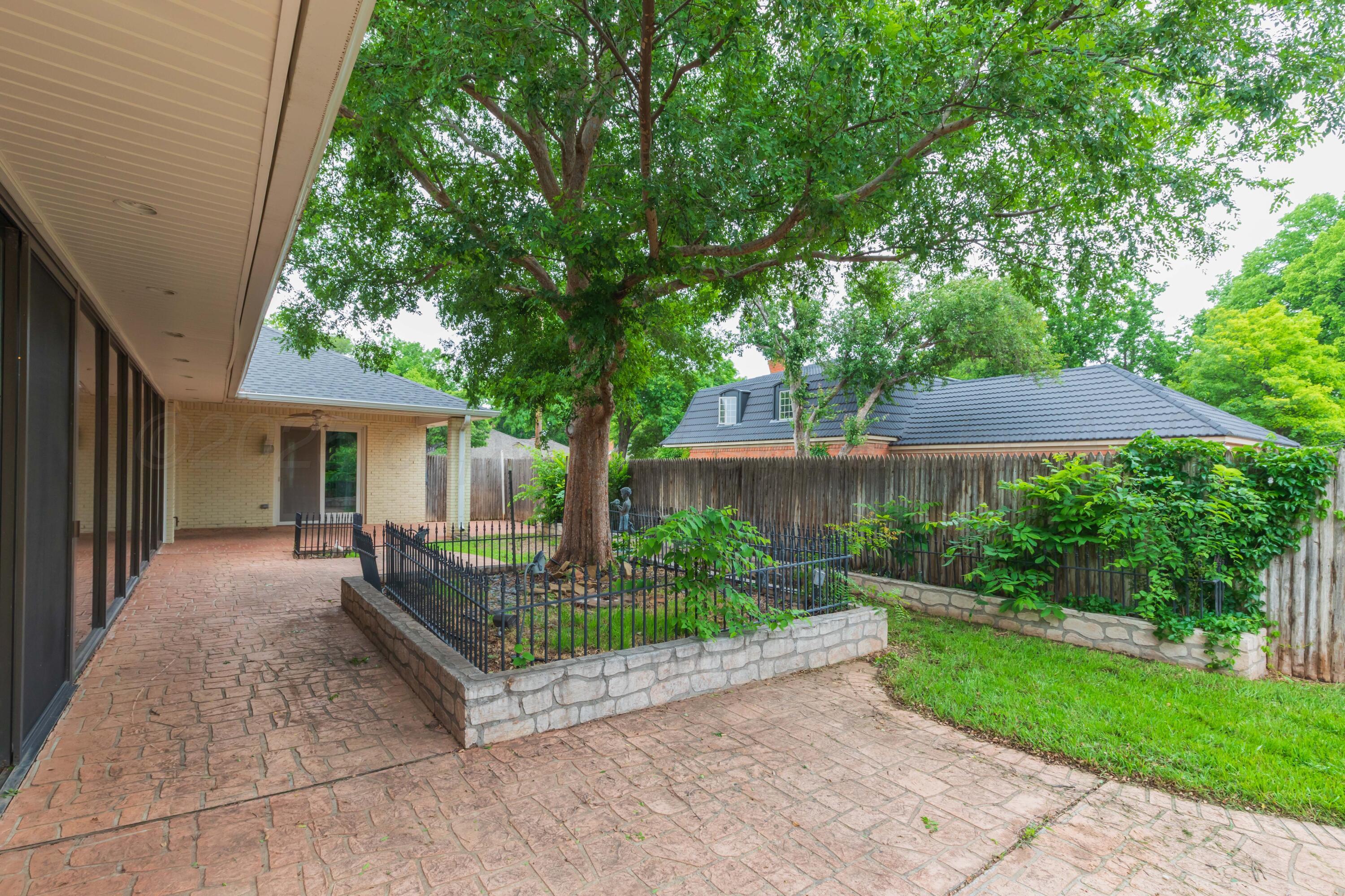 4102 Paramount Boulevard Amarillo, TX 79109 - Photo 12 of 73 a view of a house with backyard and a tree