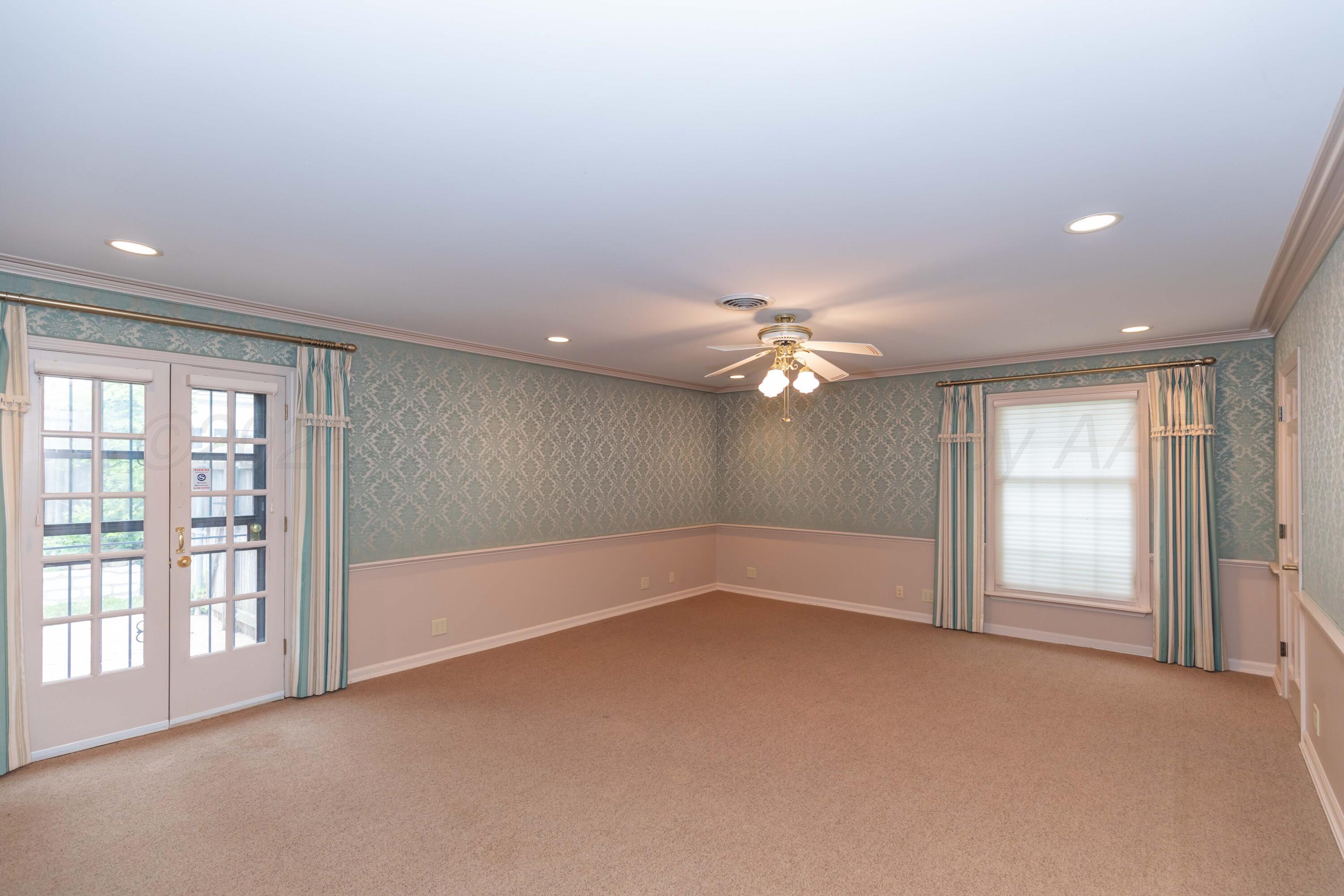 4102 Paramount Boulevard Amarillo, TX 79109 - Photo 23 of 73 an empty room with windows and chandelier fan