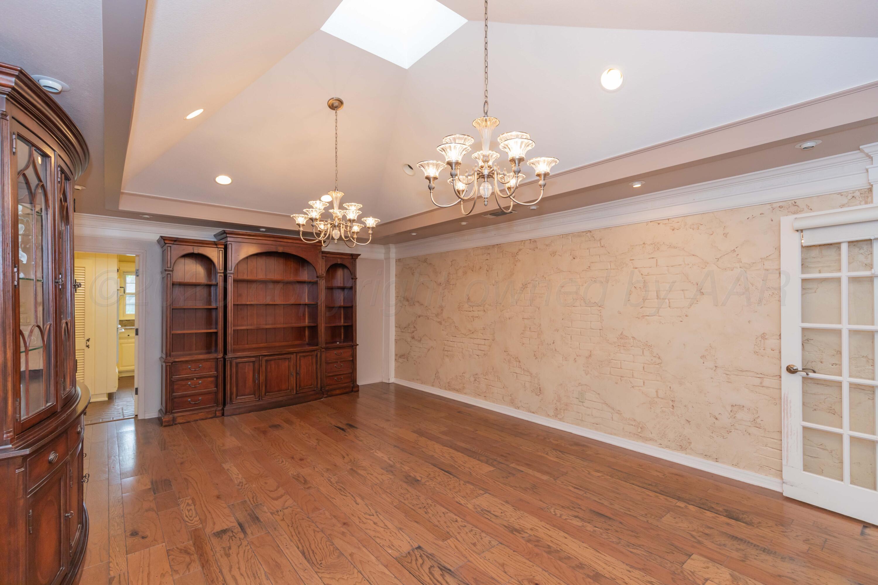 4102 Paramount Boulevard Amarillo, TX 79109 - Photo 41 of 73 a view of a room with chandelier and wooden floor