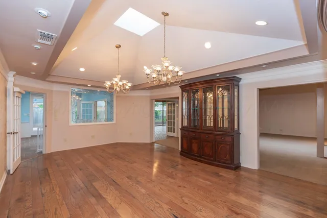 a view of an empty room with a fireplace and a window