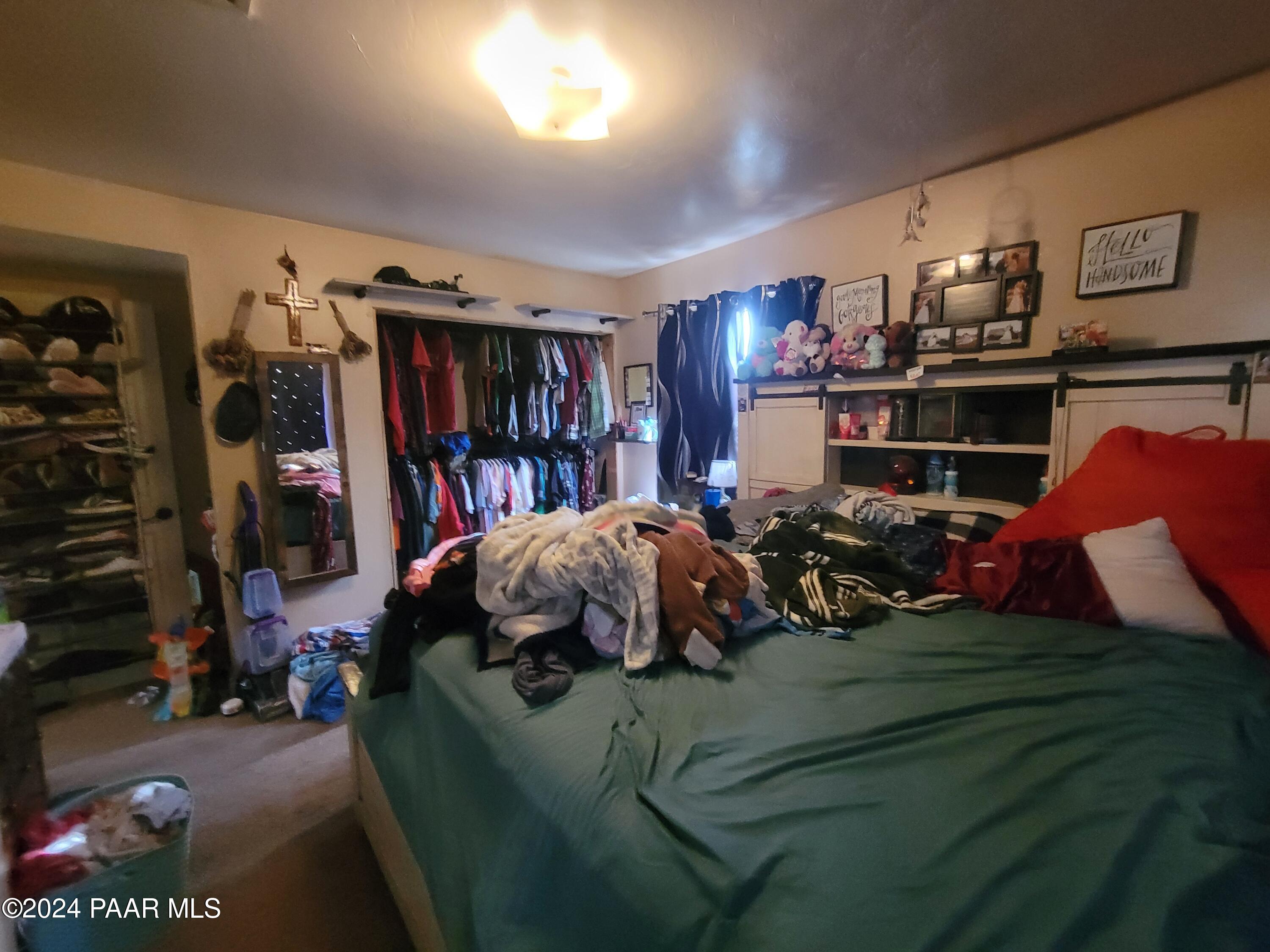 9840 Eighth Street Mayer, AZ 86333 - Photo 12 of 17 a living room with lots of furniture and a book shelf