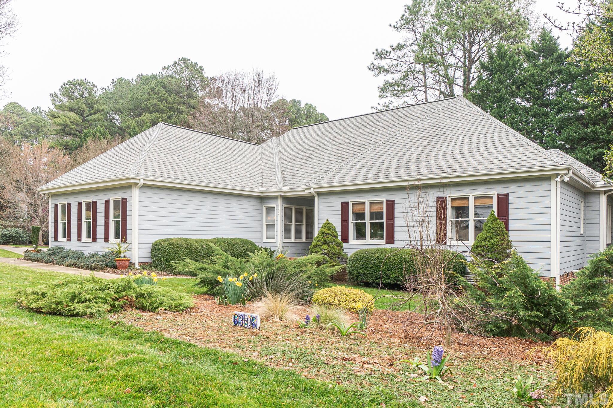 6316 Ashley Ridge Drive Raleigh, NC 27612 - Photo 4 of 45 a front view of a house with a yard and trees