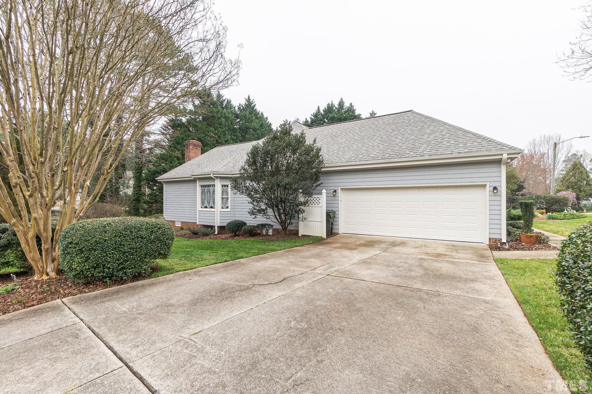 6316 Ashley Ridge Drive Raleigh, NC 27612 - Photo 45 of 45 a front view of a house with a yard and garage