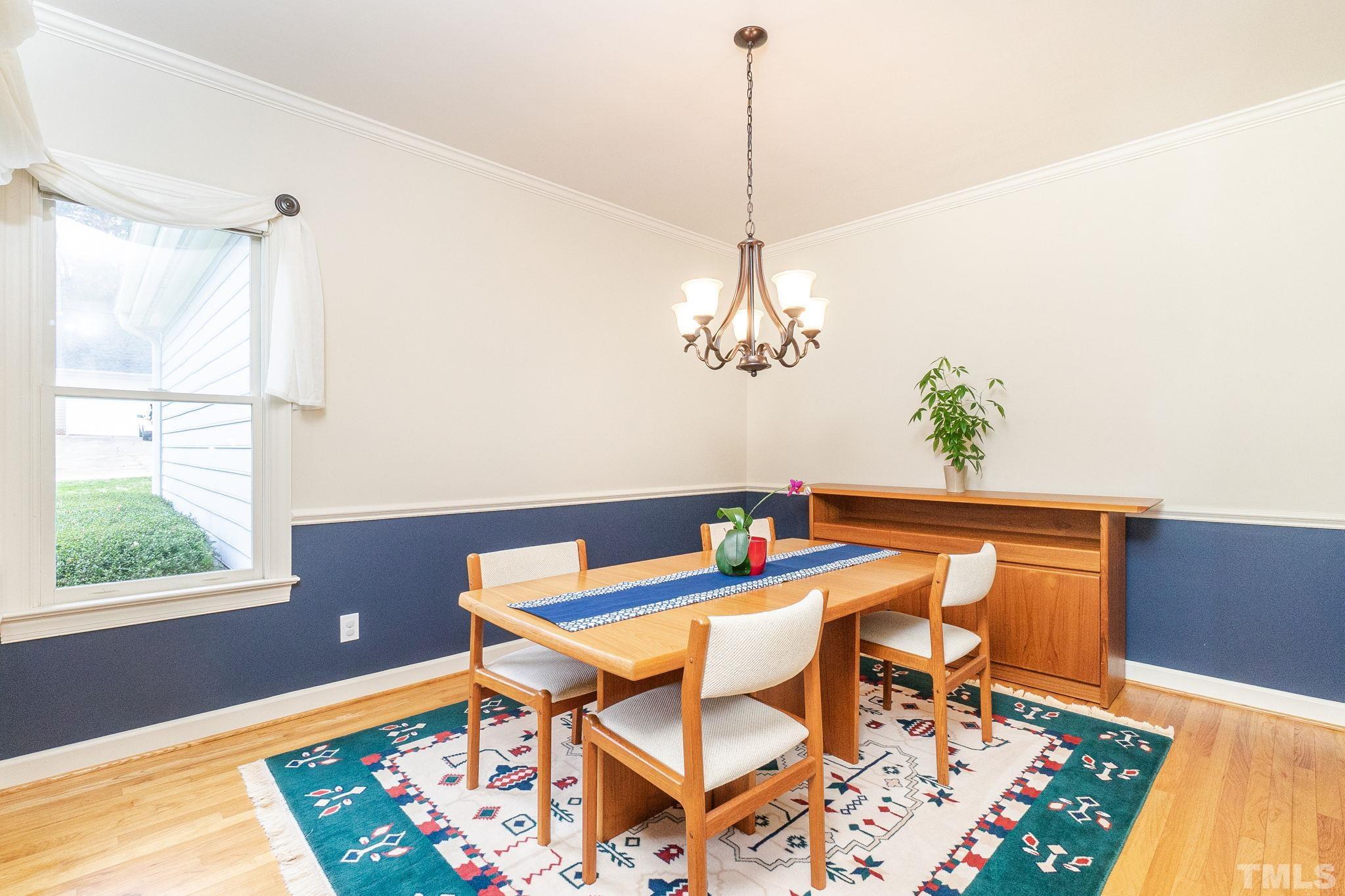 6316 Ashley Ridge Drive Raleigh, NC 27612 - Photo 9 of 45 a view of a dining room with furniture window and wooden floor