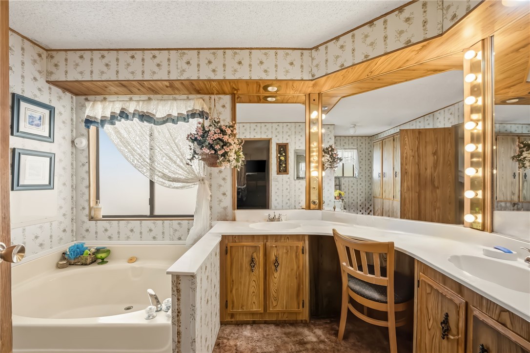 10031 Dike Road Mohave Valley, AZ 86440 - Photo 69 of 78 a bathroom with a granite countertop sink and a bathtub