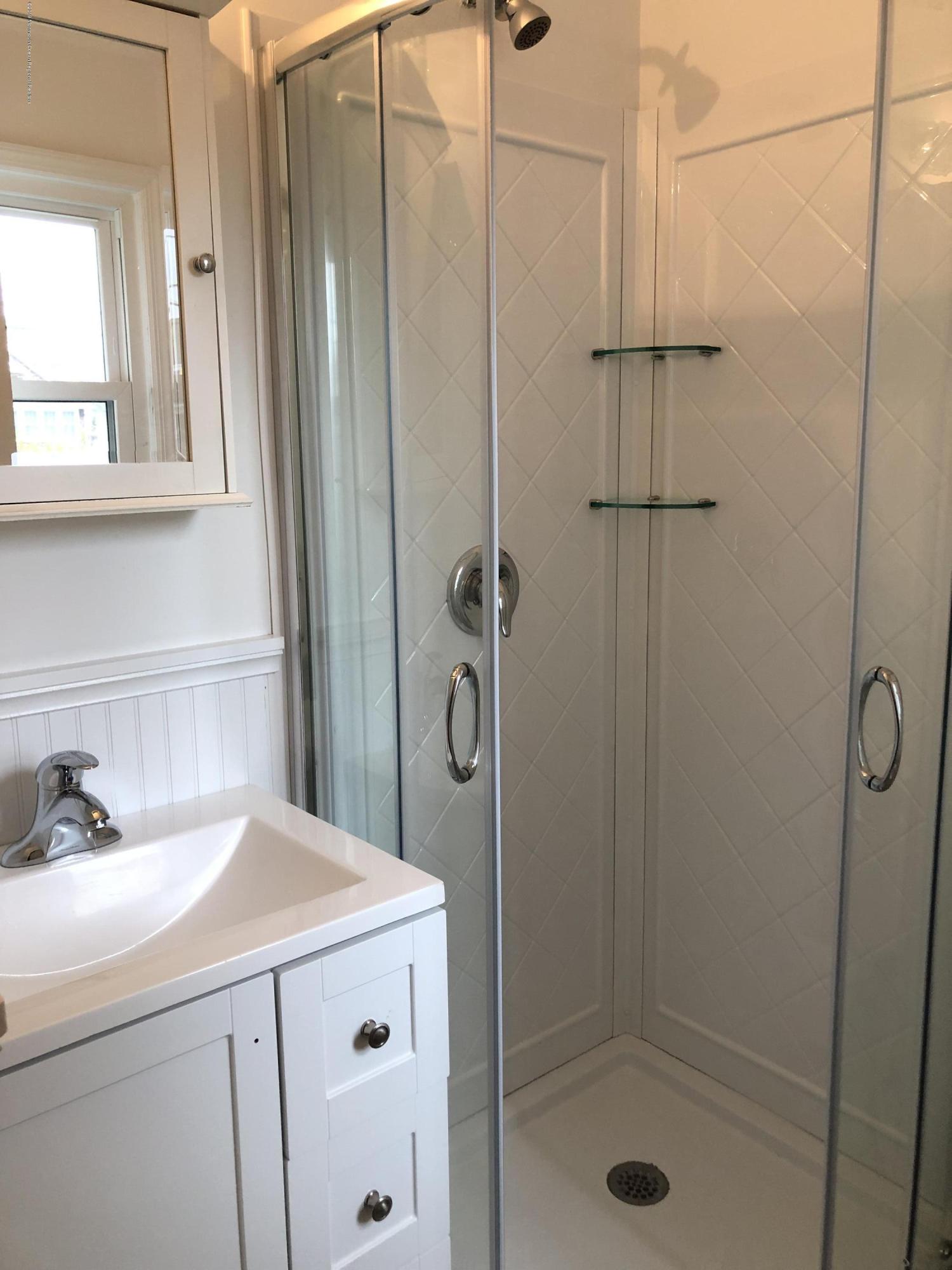 632 Main Avenue, Unit 5 Point Pleasant Beach, NJ 08742 - Photo 12 of 16 a bathroom with a shower and a sink
