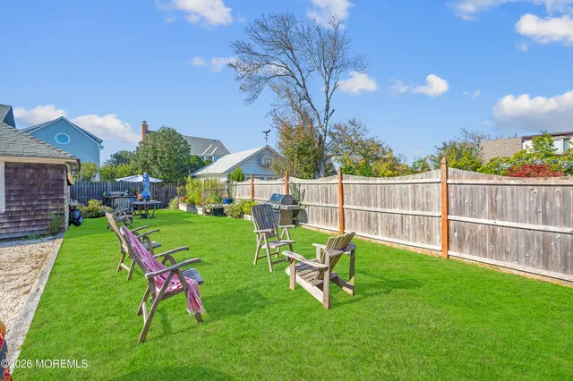 a view of a house with a yard porch and sitting area