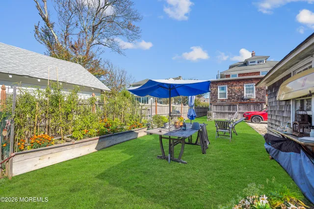a view of a chairs and table in backyard of the house