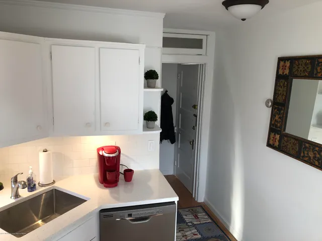 a kitchen with a sink cabinets and a refrigerator