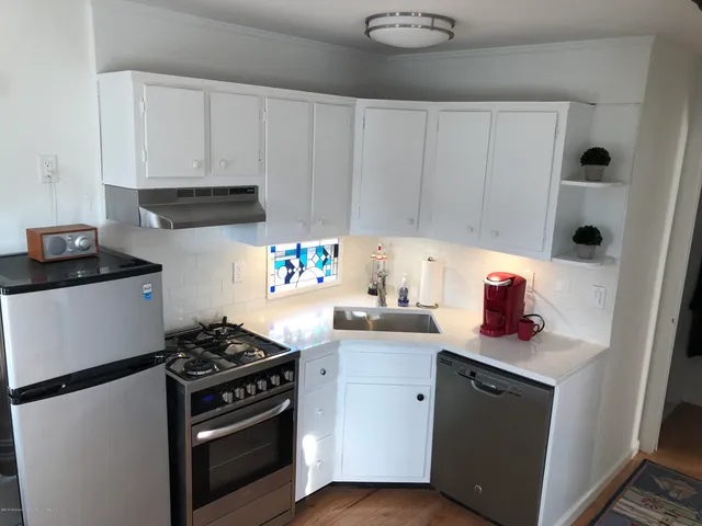 a kitchen with stainless steel appliances granite countertop a stove and a cabinets