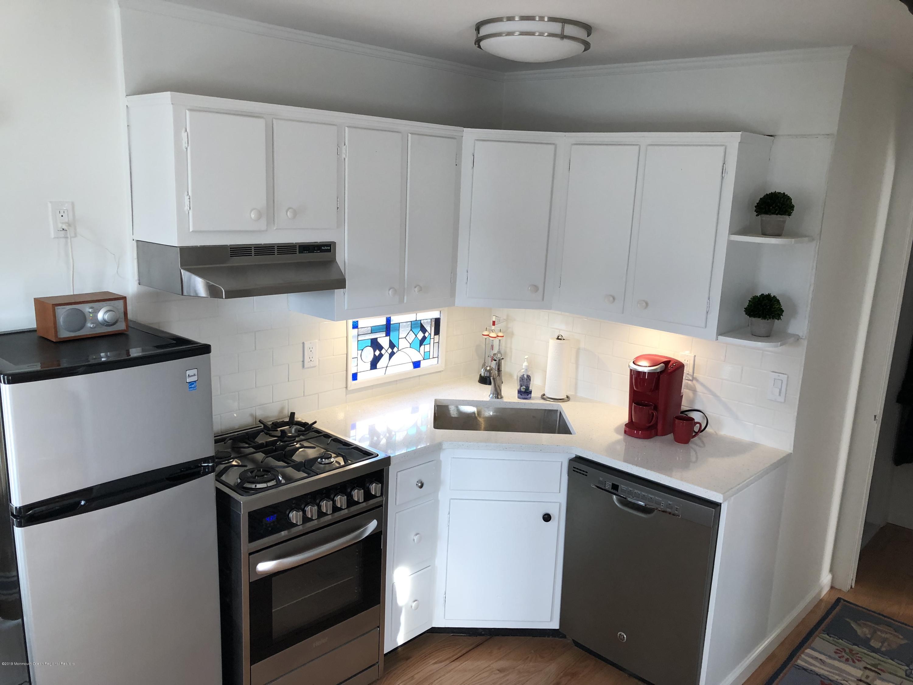 632 Main Avenue, Unit 5 Point Pleasant Beach, NJ 08742 - Photo 5 of 16 a kitchen with stainless steel appliances granite countertop a stove and a cabinets