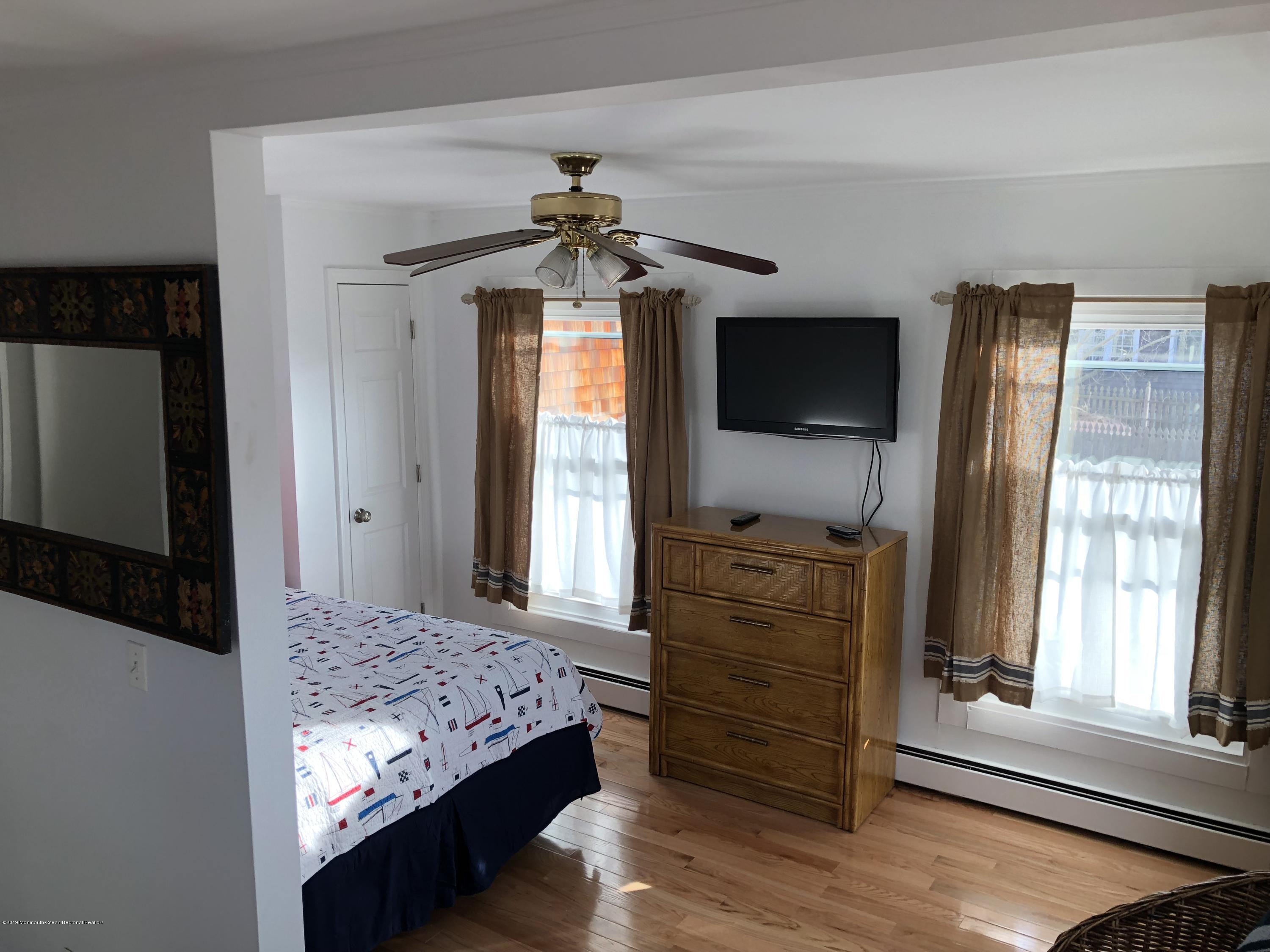 632 Main Avenue, Unit 5 Point Pleasant Beach, NJ 08742 - Photo 9 of 16 a bedroom with a bed and a flat screen tv