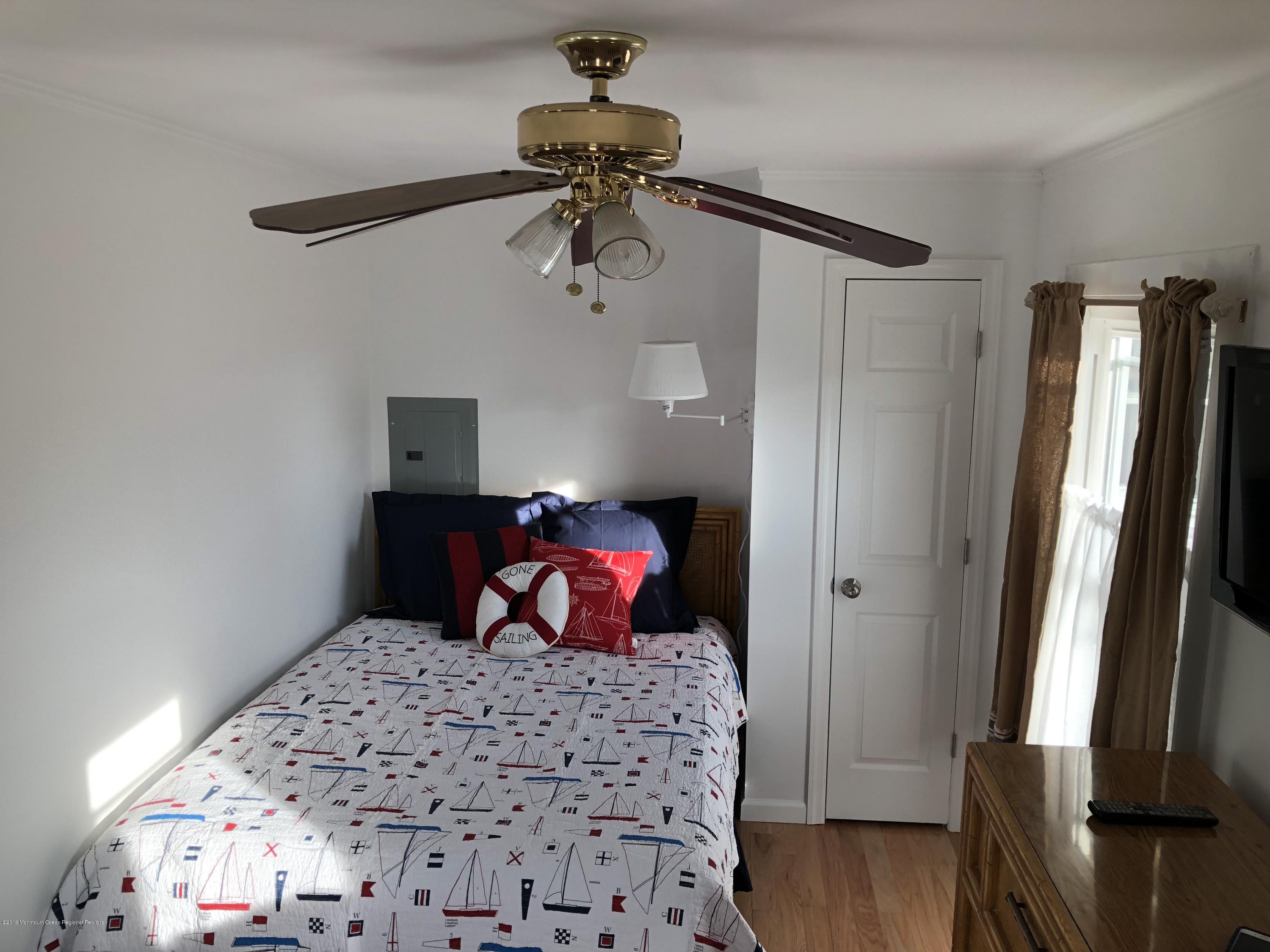 632 Main Avenue, Unit 5 Point Pleasant Beach, NJ 08742 - Photo 10 of 16 a bedroom with a bed and wooden floor