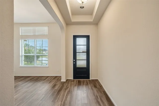 a large kitchen with a large counter top a sink stainless steel appliances and cabinets