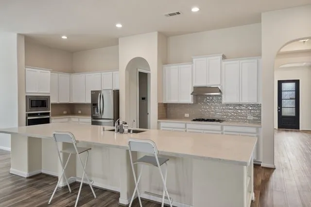 a bathroom with double vanity sinks and a mirror
