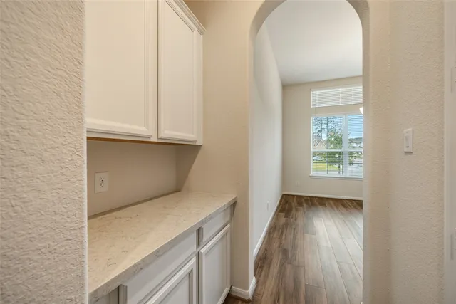 a bathroom with a tub sink double vanity granite tub shower and mirror