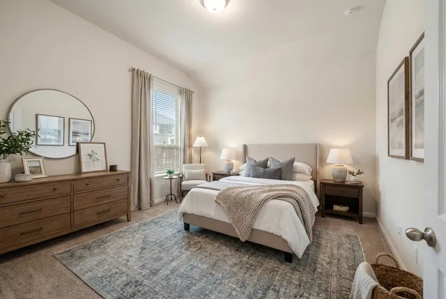 an empty room with wooden floor cabinet and windows
