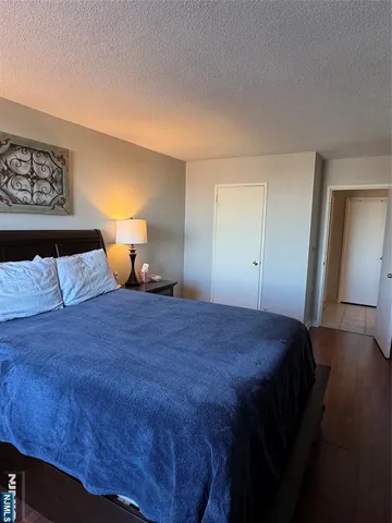 a bedroom with a bed and a night stand