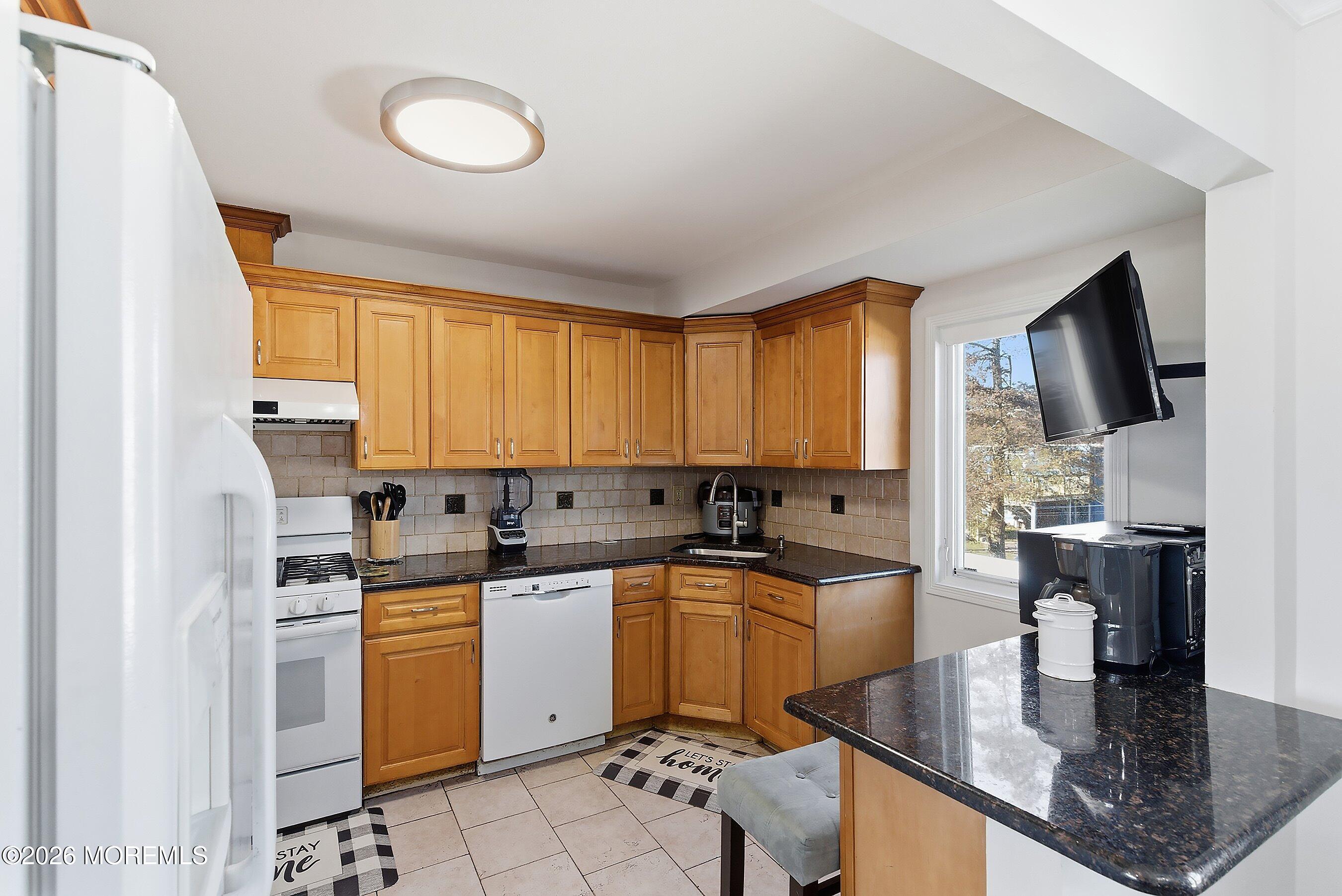 636 Hill Road Toms River, NJ 08753 - Photo 10 of 31 a kitchen with a sink a stove and cabinets
