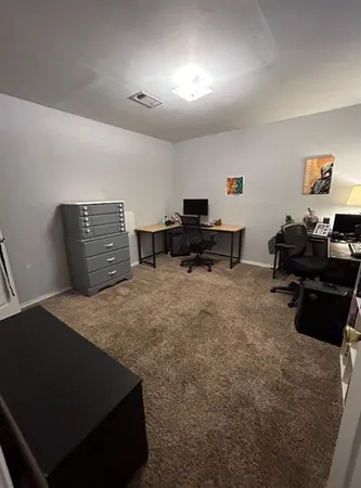 a bedroom with furniture and a lamp