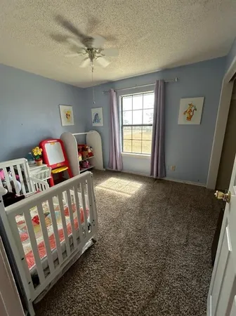 a bedroom with furniture and a window