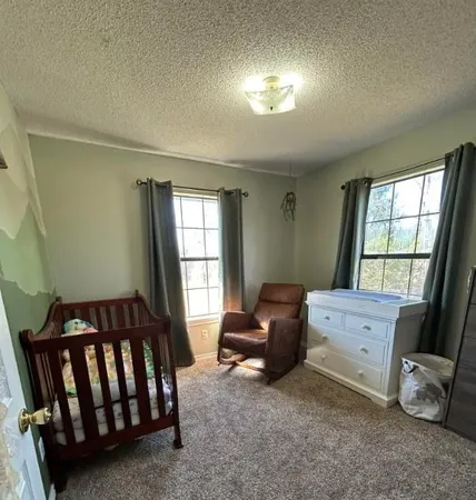 a bedroom with furniture and a window