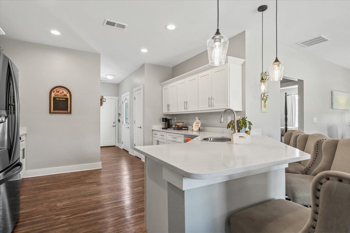 415 Abbey Road, Unit D Munford, TN 38058 - Photo 14 of 35 Kitchen featuring a stainless steel sink, white cabinetry, integrated range hood, and pendant lighting