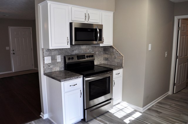 48 Ramsey Road Phenix City, AL 36869 - Photo 8 of 23 a kitchen with stainless steel appliances granite countertop a stove microwave and sink