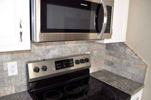 48 Ramsey Road Phenix City, AL 36869 - Photo 9 of 23 a kitchen with granite countertop a stove and a microwave
