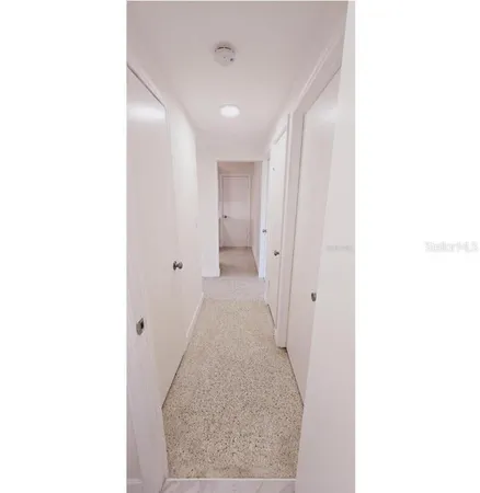 a view of a hallway with white walls