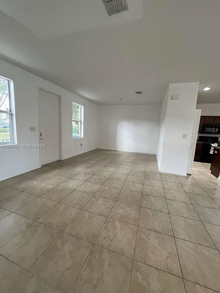 11665 Southwest 244 Street, Unit 116 Homestead, FL 33032 - Photo 11 of 32 a view of an empty room and window